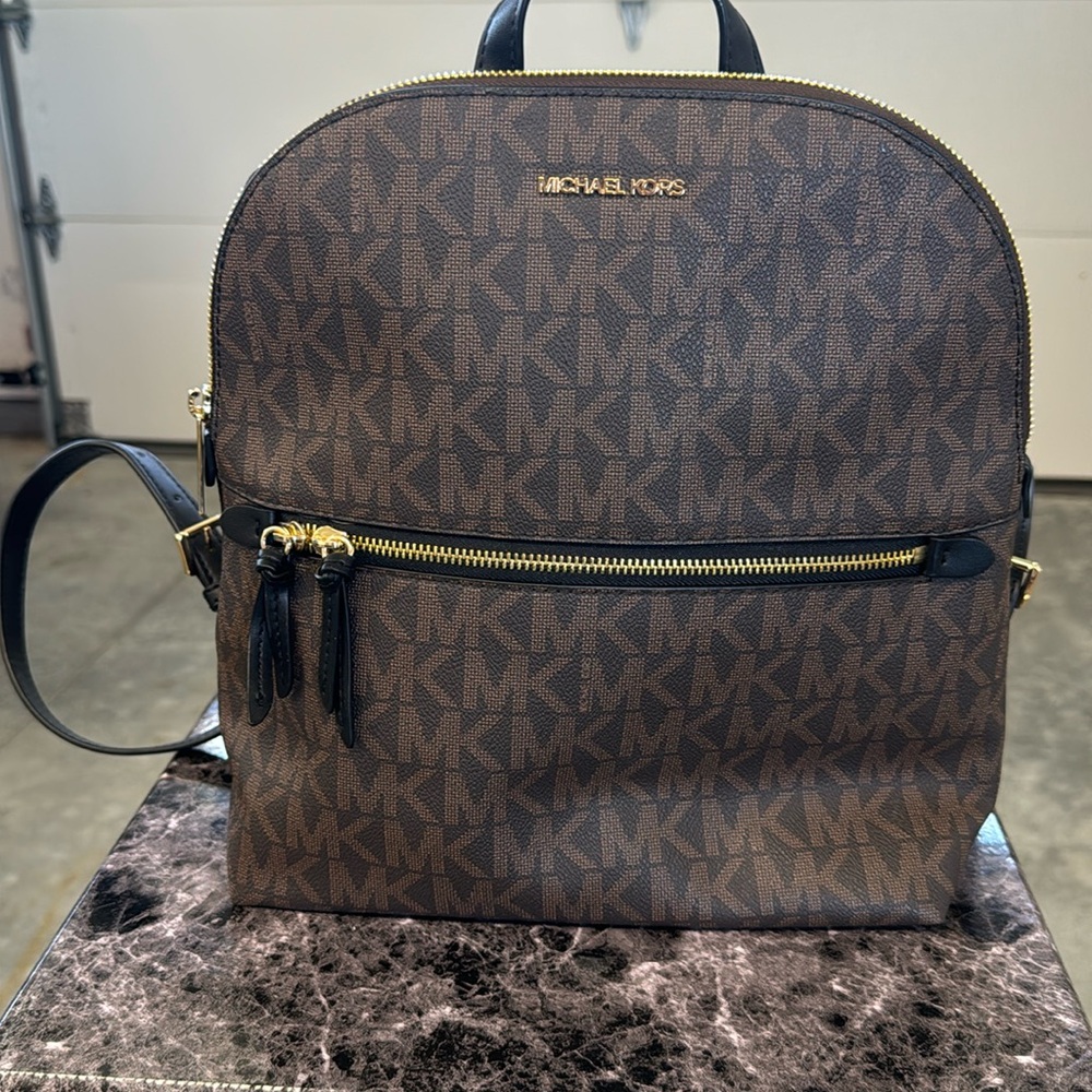 Brown and black Michael Kors Dallas slim backpack